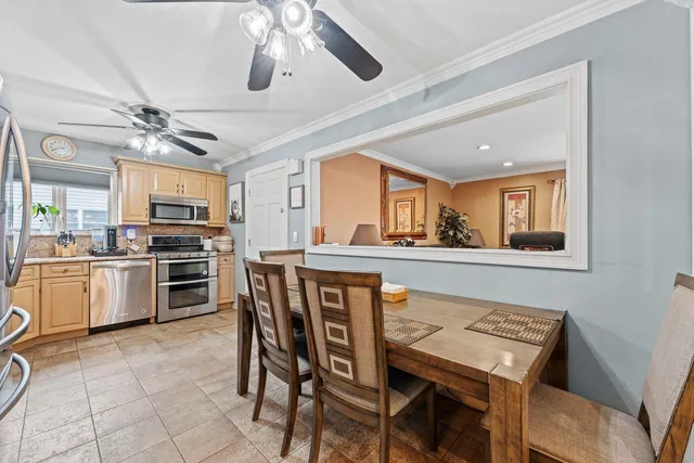 a view of a dining room with furniture and a kitchen