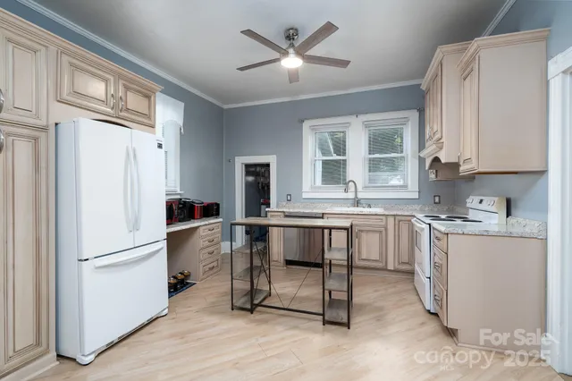 a kitchen with granite countertop a sink counter top space cabinets and stainless steel appliances