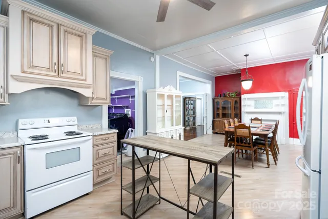 a kitchen with stainless steel appliances granite countertop a sink stove and cabinets