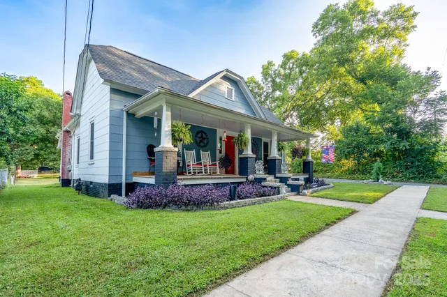 a front view of a house with garden and porch