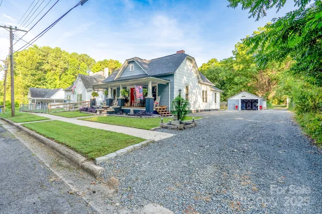 a front view of a house with a yard and trees