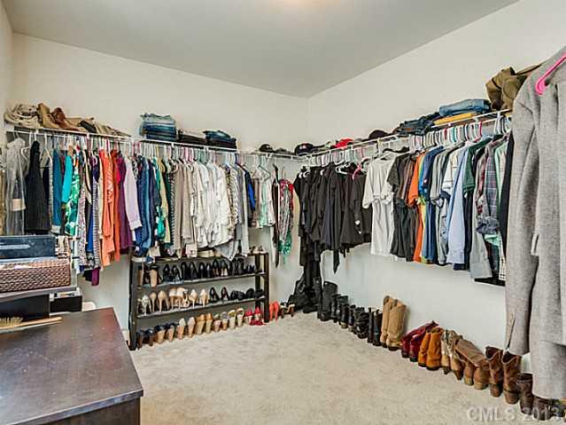 10628 Pointer Ridge Drive Charlotte, NC 28214 - Photo 12 of 16 a view of walk in closet with clothes and shoes