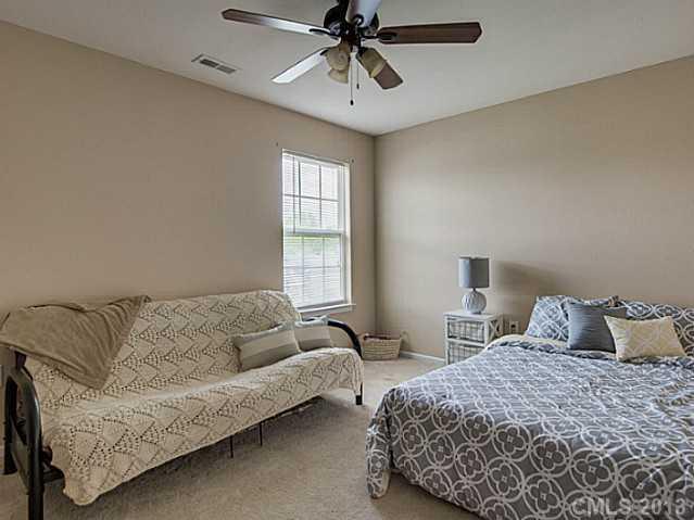 10628 Pointer Ridge Drive Charlotte, NC 28214 - Photo 13 of 16 a bedroom with a bed couches and window