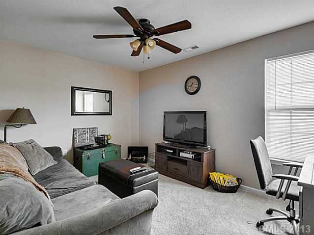 10628 Pointer Ridge Drive Charlotte, NC 28214 - Photo 14 of 16 a living room with furniture a flat screen tv and a window