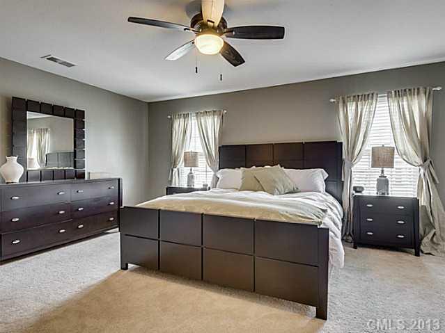 10628 Pointer Ridge Drive Charlotte, NC 28214 - Photo 9 of 16 a bedroom with a bed and a dresser
