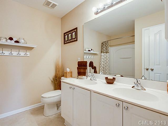 10628 Pointer Ridge Drive Charlotte, NC 28214 - Photo 10 of 16 a bathroom with a sink mirror and toilet