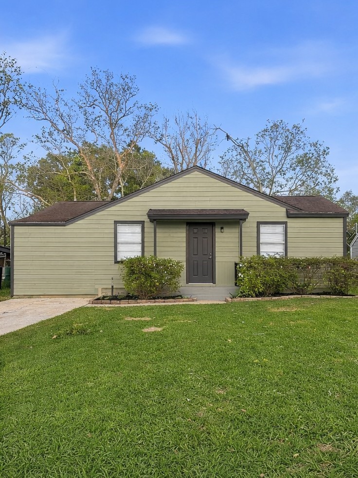 a front view of a house with a garden