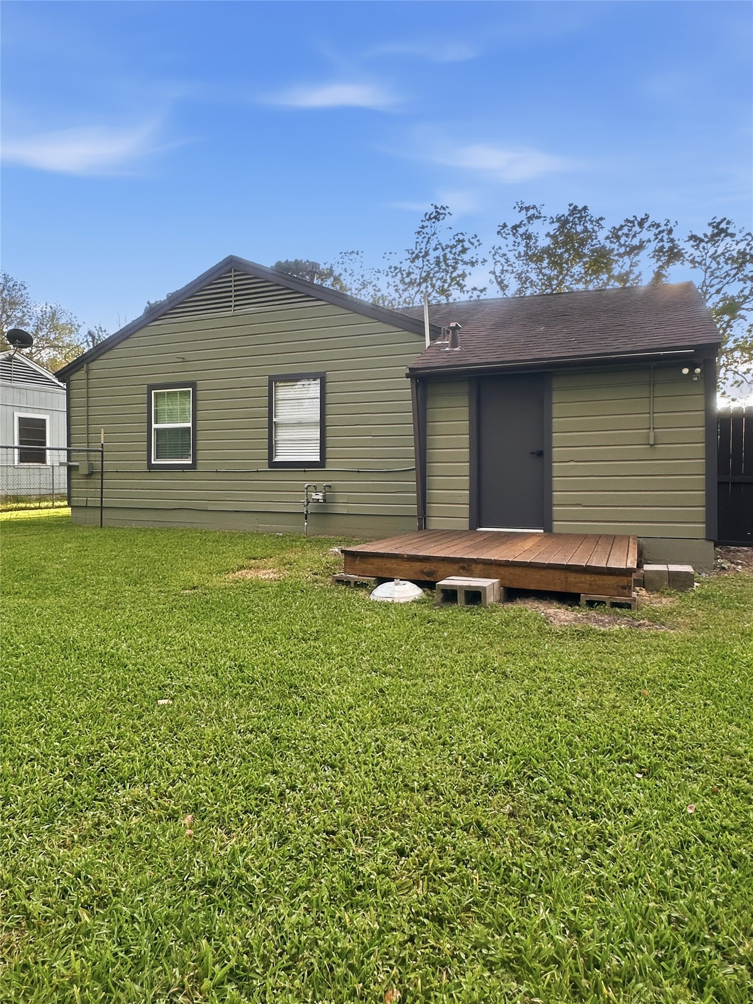 1308 North Rockisland Street Angleton, TX 77515 - Photo 12 of 13 a backyard of a house with barbeque oven and outdoor seating