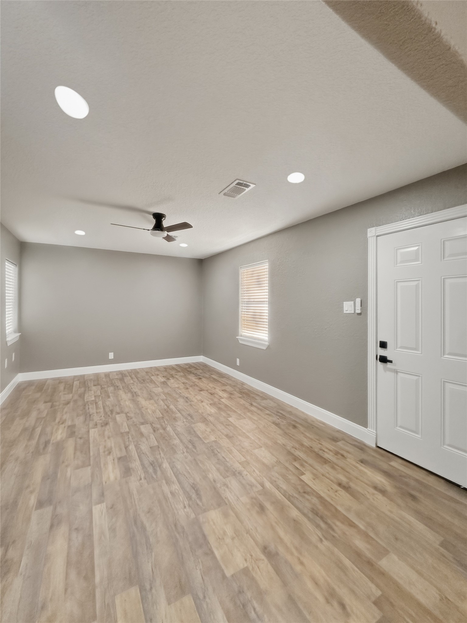 1308 North Rockisland Street Angleton, TX 77515 - Photo 3 of 13 a view of empty room with wooden floor and fan