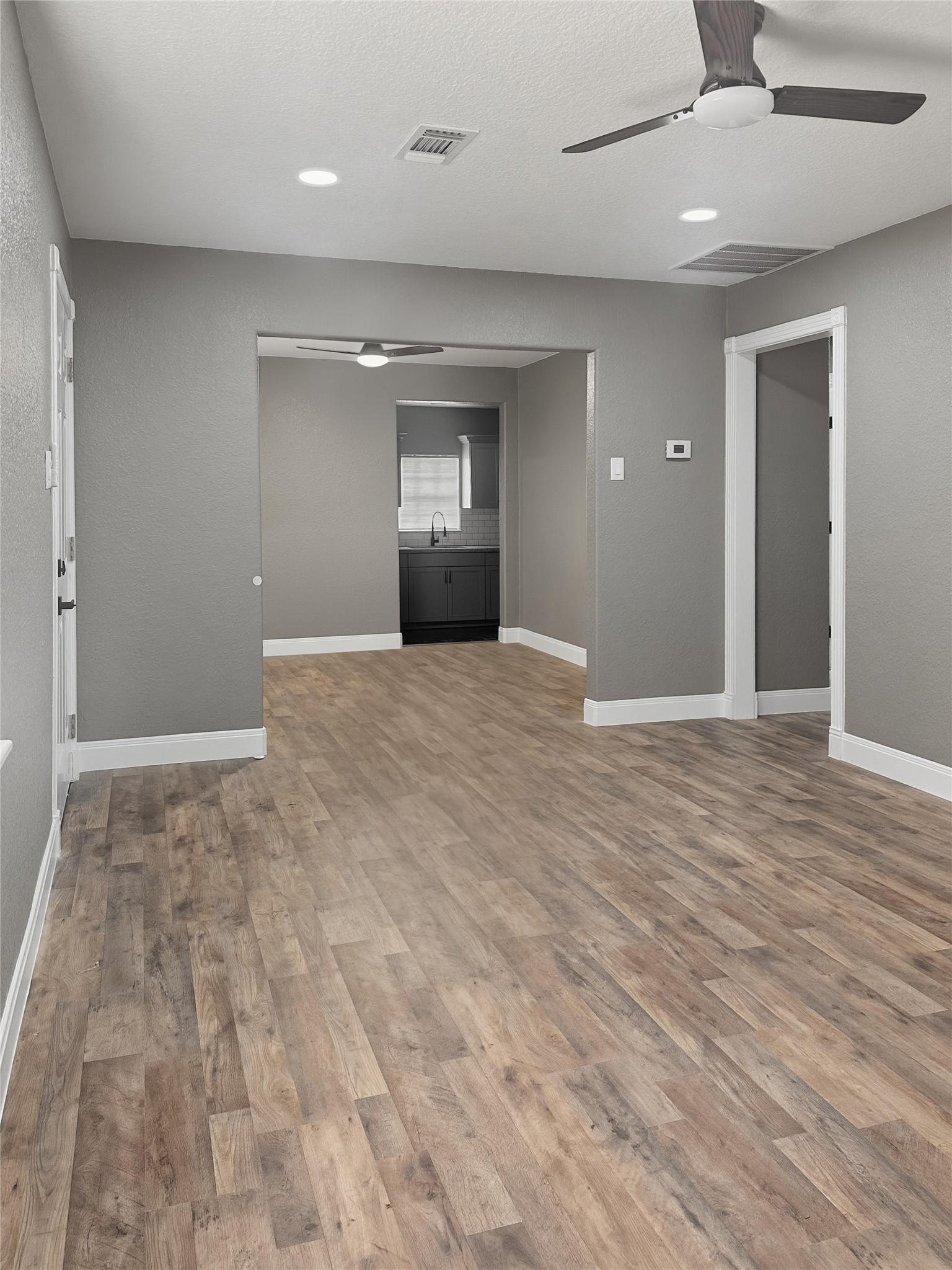 1308 North Rockisland Street Angleton, TX 77515 - Photo 6 of 13 an empty room with wooden floor and windows