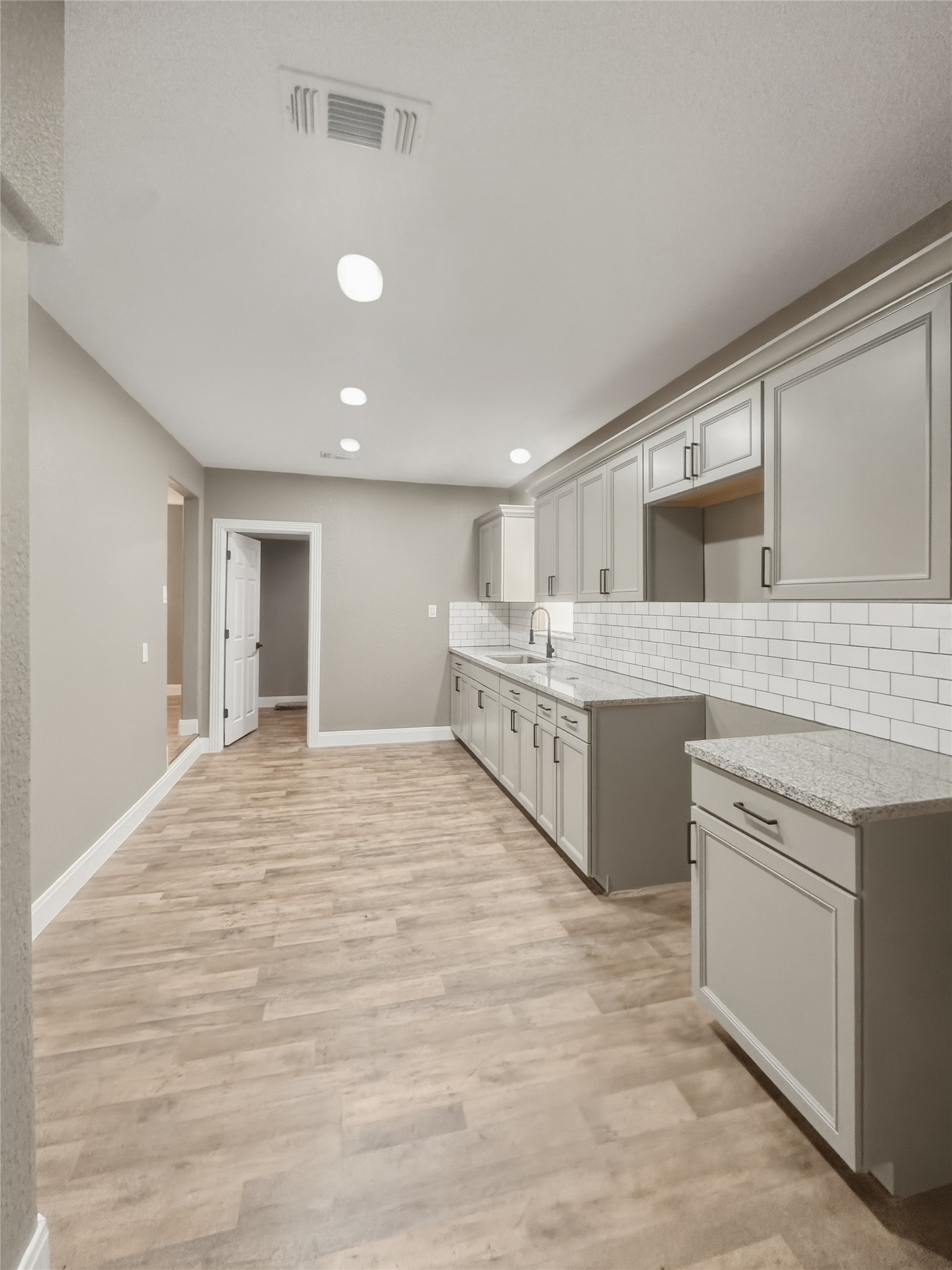 1308 North Rockisland Street Angleton, TX 77515 - Photo 7 of 13 a large white kitchen with a stove top oven sink and cabinets