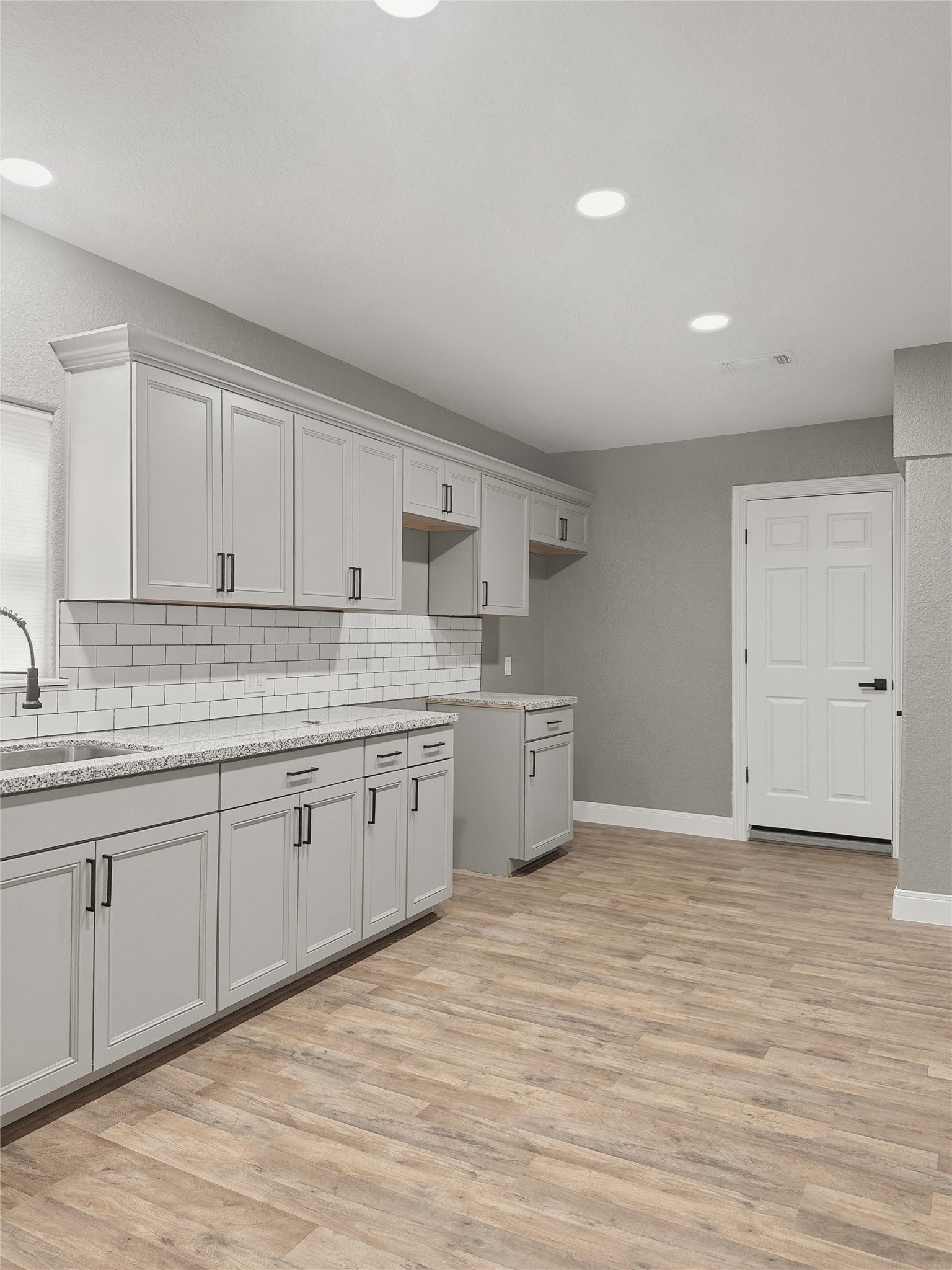 1308 North Rockisland Street Angleton, TX 77515 - Photo 8 of 13 a kitchen with granite countertop a sink cabinets and wooden floor
