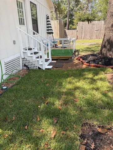 a view of a chair and table in backyard