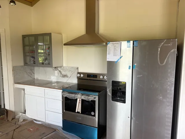 a kitchen with a stove and a refrigerator