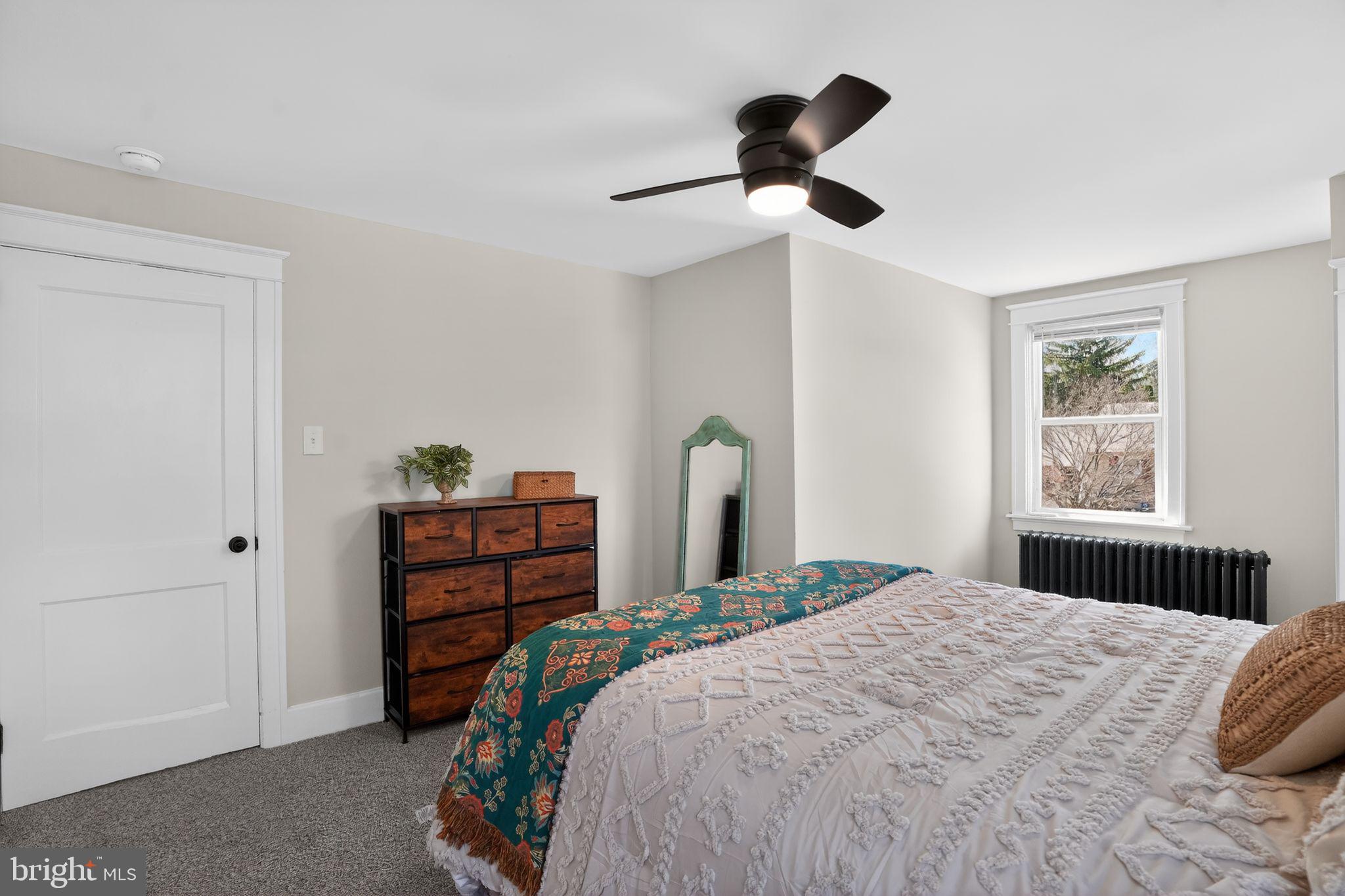 424 Arch Street Spring City, PA 19475 - Photo 23 of 32 a bedroom with a bed and a chandelier