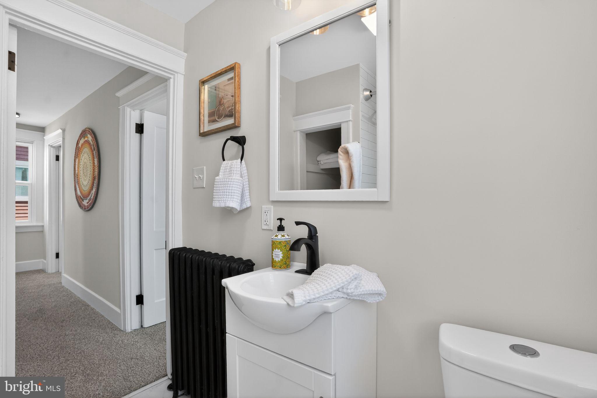 424 Arch Street Spring City, PA 19475 - Photo 28 of 32 a bathroom with a toilet a sink and a mirror