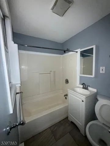 a bathroom with a sink mirror toilet and bathtub