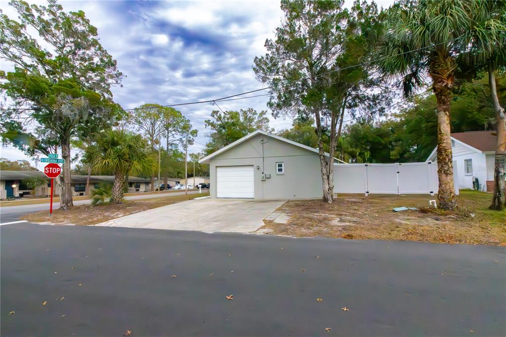 6414 Indiana Avenue New Port Richey, FL 34653 - Photo 16 of 31 a view of road and house with large trees in the background