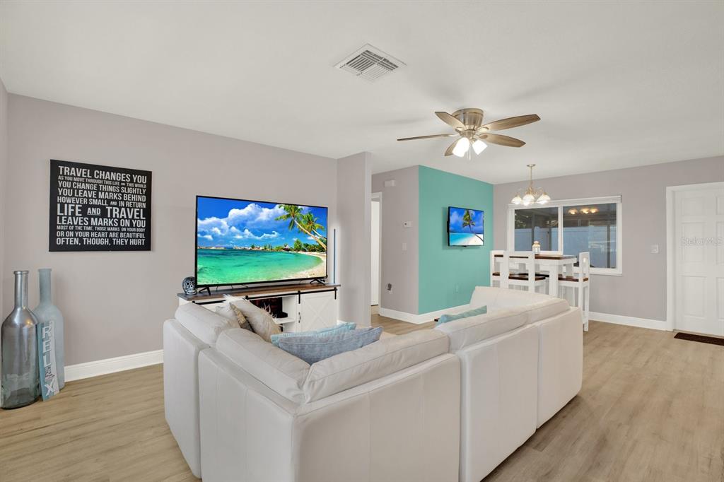 6414 Indiana Avenue New Port Richey, FL 34653 - Photo 2 of 31 a living room with furniture and a flat screen tv