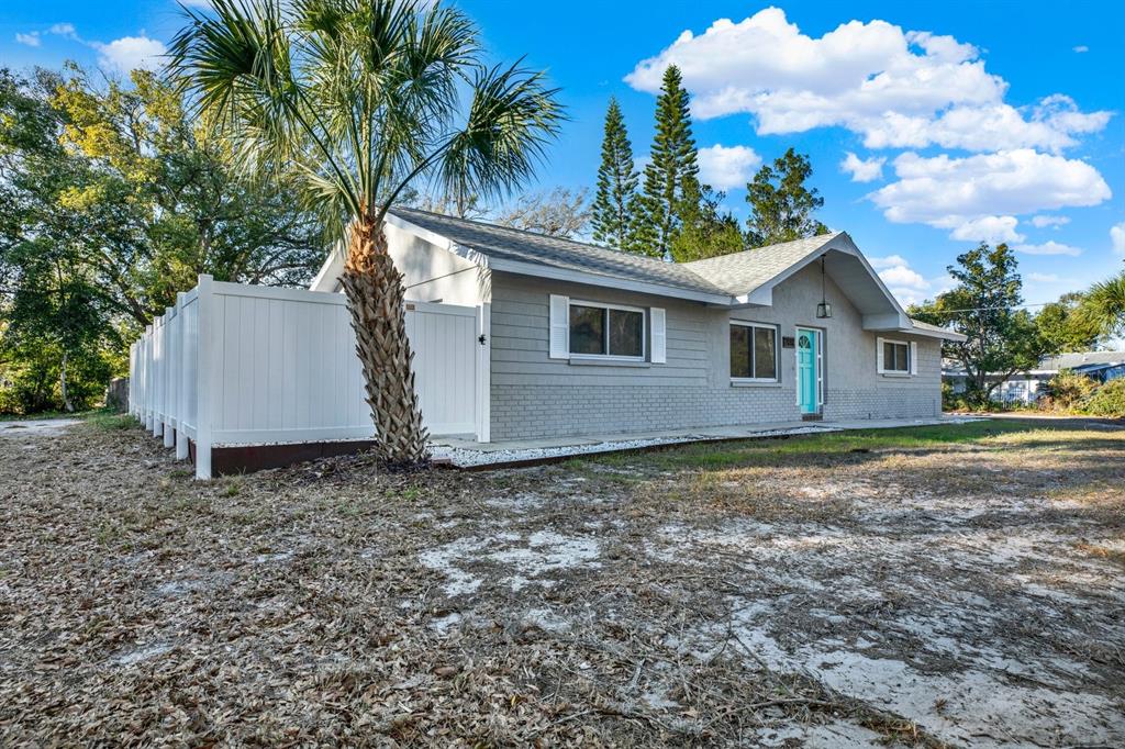 6414 Indiana Avenue New Port Richey, FL 34653 - Photo 24 of 31 a view of a house with a yard and garage