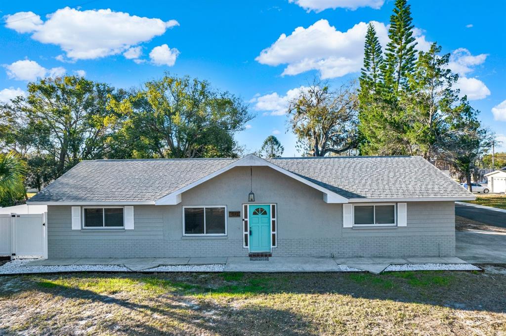 6414 Indiana Avenue New Port Richey, FL 34653 - Photo 31 of 31 a front view of a house with a yard