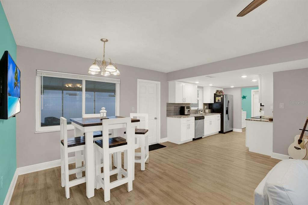 6414 Indiana Avenue New Port Richey, FL 34653 - Photo 4 of 31 a view of a dining room with furniture and wooden floor
