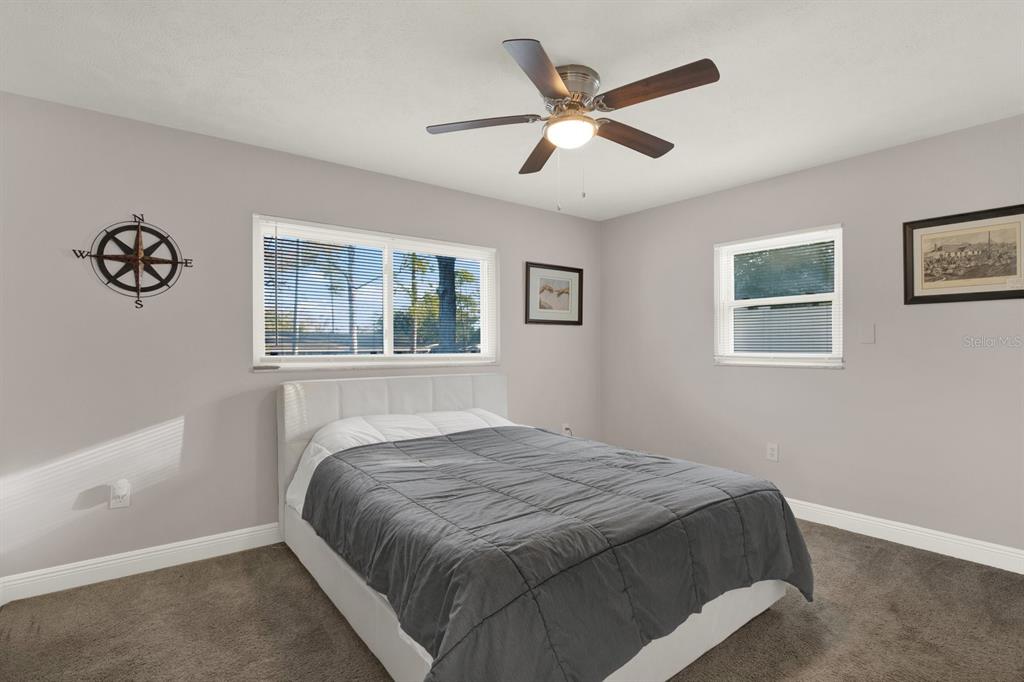 6414 Indiana Avenue New Port Richey, FL 34653 - Photo 6 of 31 a bedroom with a large bed and a window