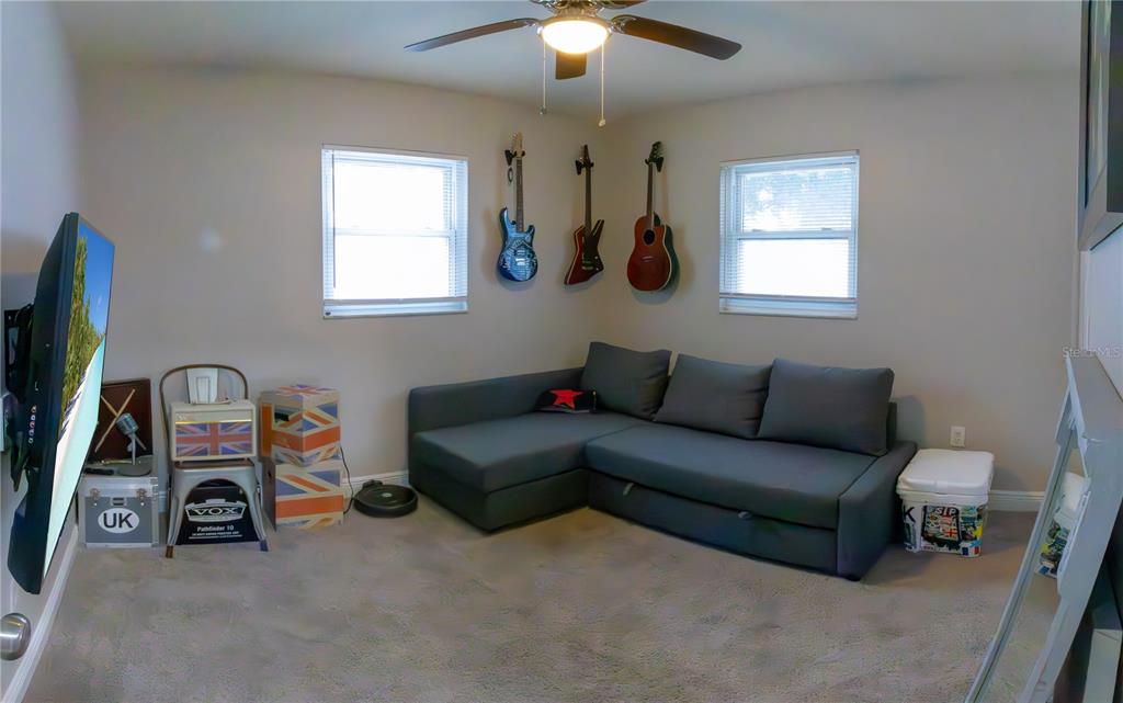 6414 Indiana Avenue New Port Richey, FL 34653 - Photo 8 of 31 a living room with furniture a window and a flat screen tv