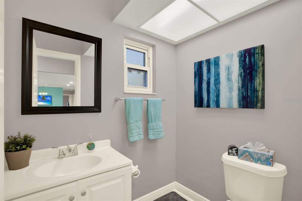 6414 Indiana Avenue New Port Richey, FL 34653 - Photo 10 of 31 a bathroom with a toilet sink and mirror