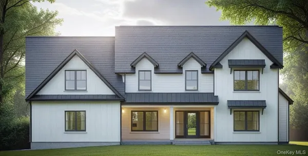 a front view of a house with yard and garage