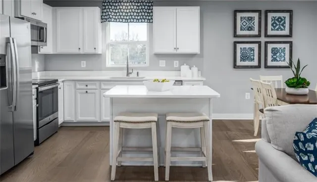 a kitchen with stainless steel appliances a stove a sink dishwasher and cabinets