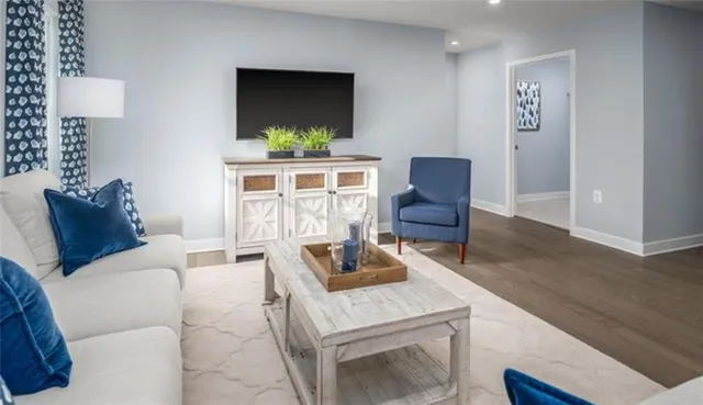 a large bed sitting in a bedroom next to a window and a lamp