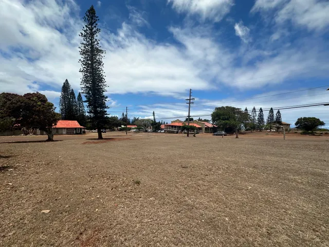 a view of road with card parked on side and road