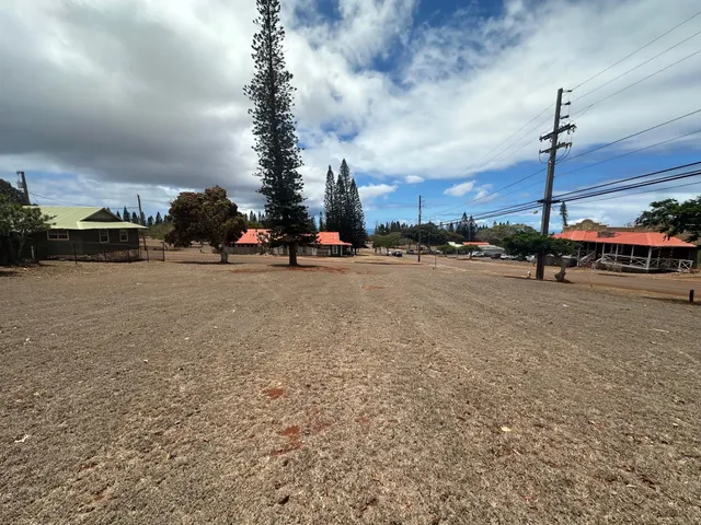 a view of a street with cars on both side of road