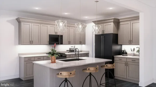 a kitchen with a sink refrigerator and microwave