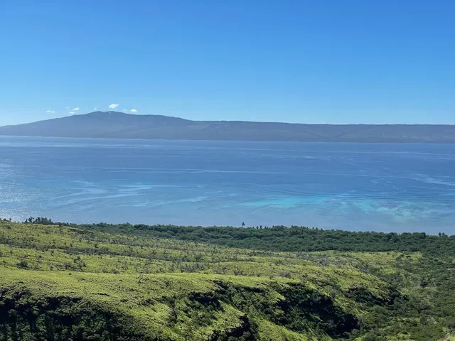 a view of an ocean beach and mountain
