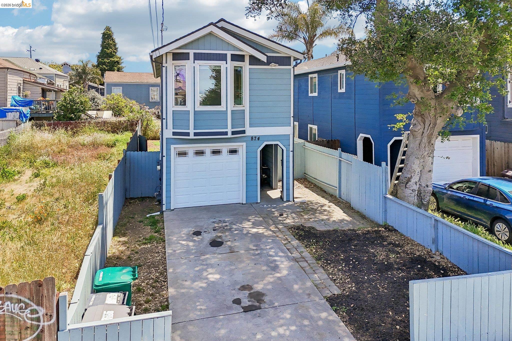 874 Pine Street Oakland, CA 94607 - Photo 28 of 39 Two-story residence featuring light blue siding with white trim accents and a bay window