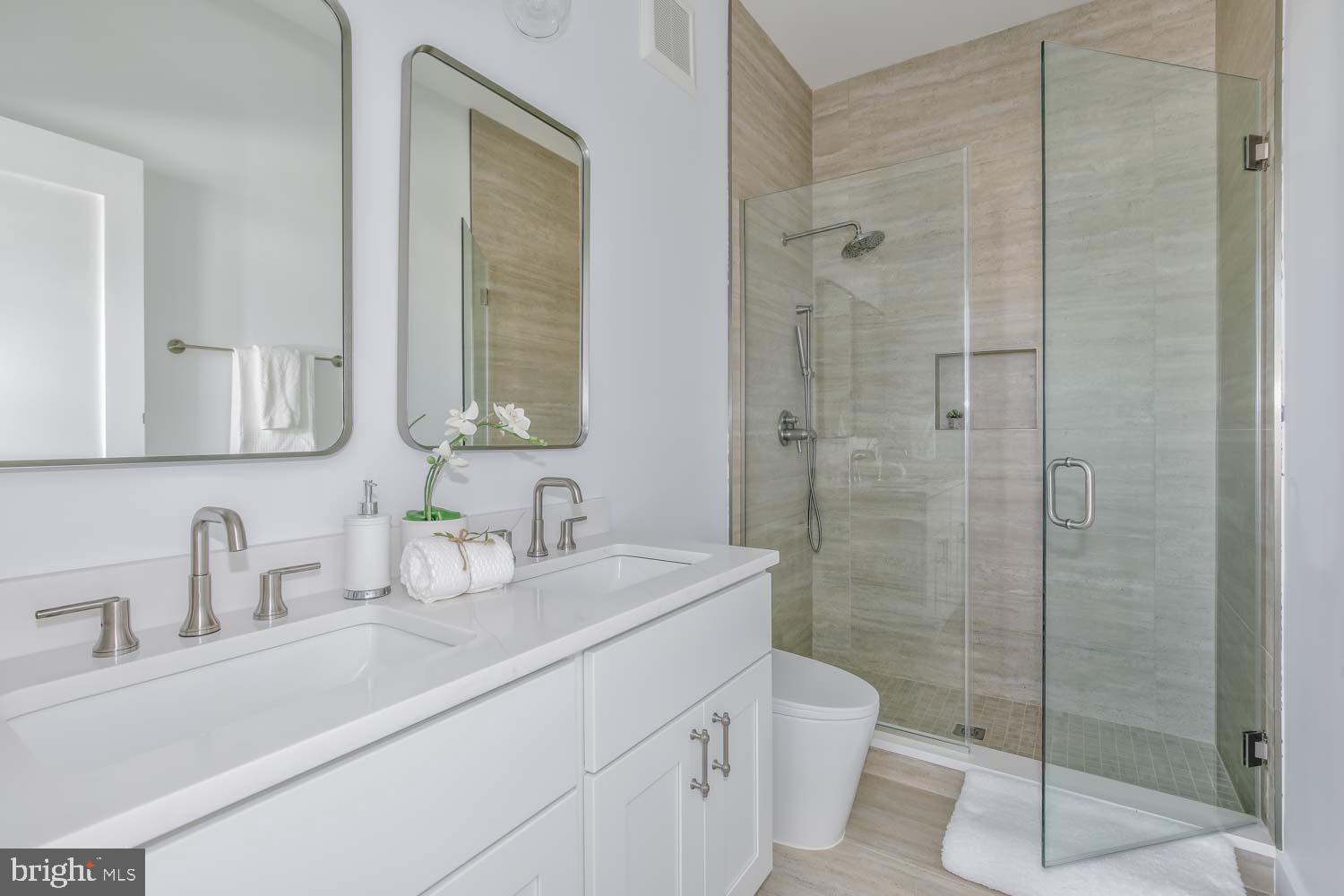 4347 Harrison Street Northwest, Unit 4 Washington, DC 20015 - Photo 11 of 18 a bathroom with a sink a toilet and shower