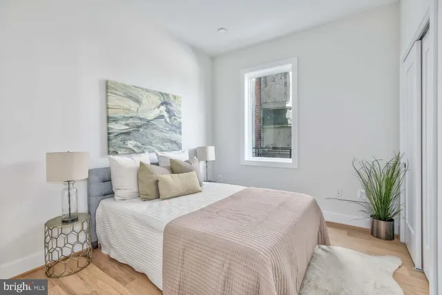 a bedroom with bed and a potted plant
