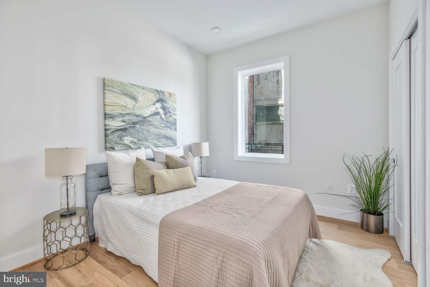 4347 Harrison Street Northwest, Unit 4 Washington, DC 20015 - Photo 12 of 18 a bedroom with bed and a potted plant