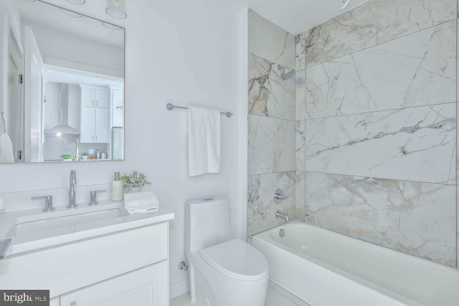4347 Harrison Street Northwest, Unit 4 Washington, DC 20015 - Photo 14 of 18 a bathroom with a sink and a bathtub