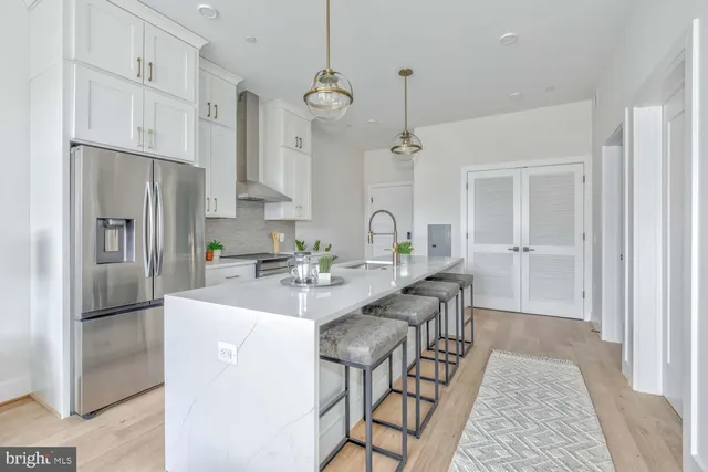 a kitchen with stainless steel appliances kitchen island a refrigerator and a stove