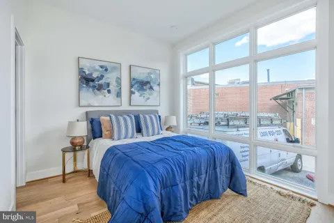 a bed sitting in a bedroom next to a window