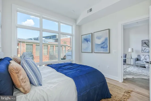 a bedroom with a large bed and a window