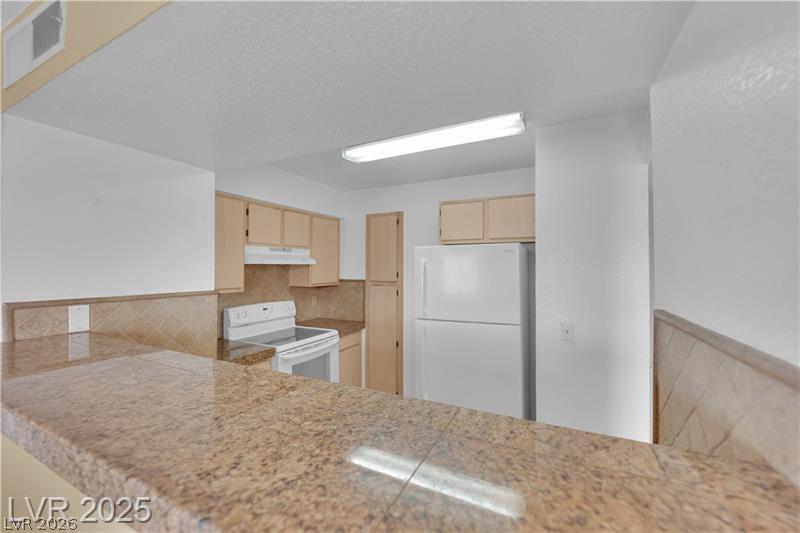 8101 West Flamingo Road, Unit 2030 Las Vegas, NV 89147 - Photo 23 of 27 A well-equipped kitchen provides essential appliances and ample counter space for daily culinary tasks.