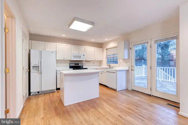 a kitchen with stainless steel appliances a refrigerator and a stove top oven