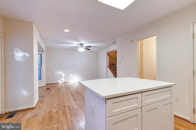 a kitchen with a wooden floor and window