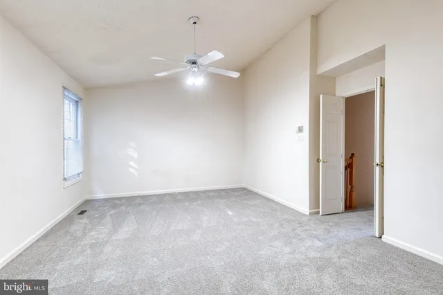 an empty room with a empty space and a ceiling fan