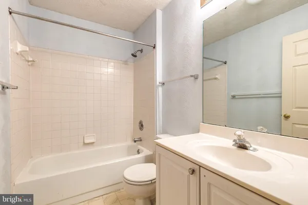 a bathroom with a sink a toilet and a bathtub