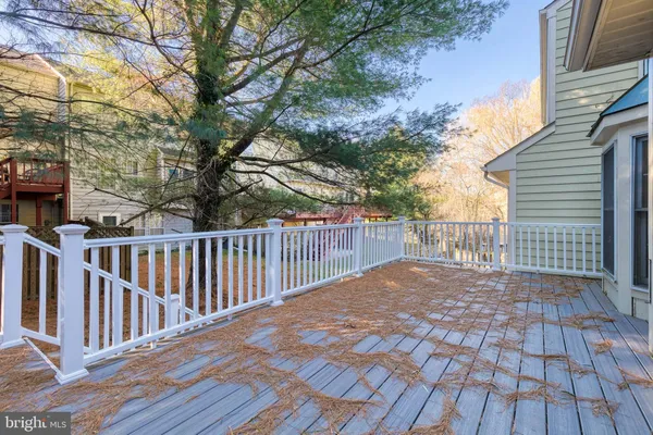 a view of backyard with wooden floor and fence
